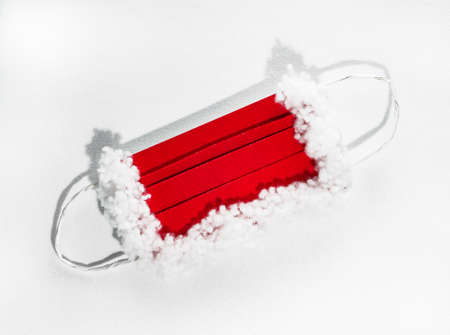 protective mask for Santa Claus, red and white on a white background with hard shadowsの写真素材