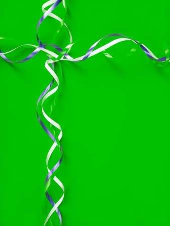 thin ribbons of colors: white, blue, green are on a green background, like on a gift boxの写真素材