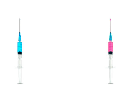 two syringes with blue and pink liquid, isolatedの写真素材