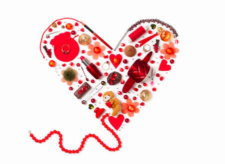 flat lay of womens gizmos in the shape of a red heartの写真素材
