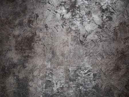 background - embossed gray-brown wall in light and dark spots and stainsの写真素材