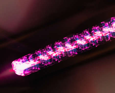 abstract blurred background, neon tube - pink energy light beam with complex spiral structure,...