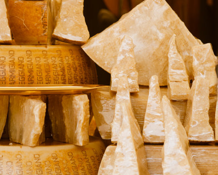 Nice, France - June 1, 2012: Hard parmesan heads and chunks on market. Cheese showcase.のeditorial素材