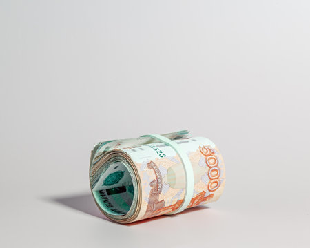 A bundle of Russian paper money in denominations of 5 thousand rubles, rolled up, side viewの写真素材