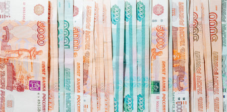 horizontal background of spread out paper money in denominations of one thousand and five thousand...