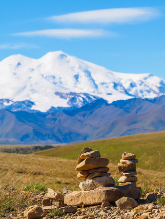 Pyramids of stones in snowy mountains, the balance of stones, the concept of life balance, harmony and meditation, gratitude to the spirits, the North Caucasus, Elbrusの写真素材