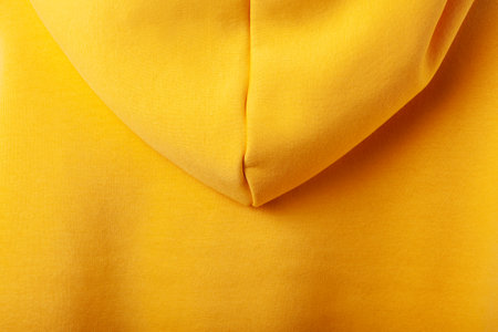 Autumn concept - yellow hoodie background, back view with hoodの写真素材