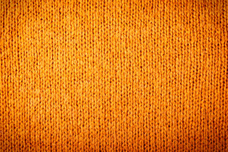 Autumn concept - background of knitted woolen brown sweater. Knit fabric texture. Close up view. Knit backgroundの写真素材