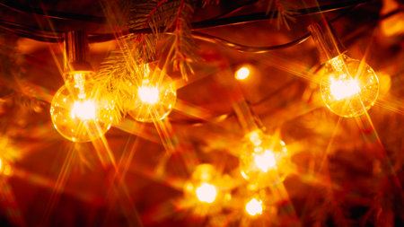 Background - electric garland with incandescent bulbs, yellow warm light, retro style, star filterの写真素材