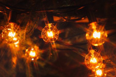 Electric garland with incandescent bulbs, yellow warm light, retro style