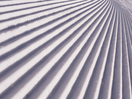 "Corduroy" after a snowcat on a slope, close-up of the snow surface of the slope after a snowcat. Ski pisteの写真素材