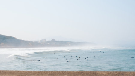 Multiple surfers riding waves along the coastline of Biarritzの写真素材
