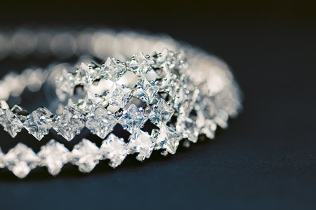 Close up of a diamond bracelet on a black surface
