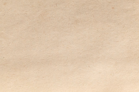 This close-up shows textured beige paper with a smooth, consistent surface and a subtle pattern. Its warm, pale hue evokes age and authenticity, ideal for vintage designsの写真素材