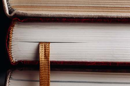 Close-up of a stack of books with a yellow bookmarkの写真素材