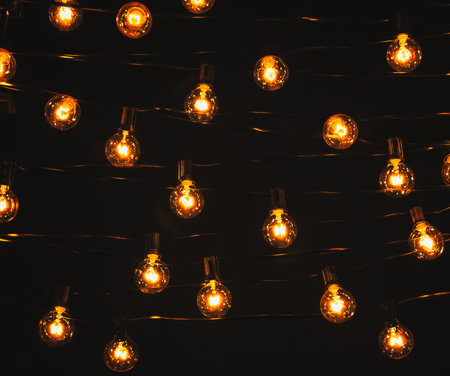 Background - electric garland with incandescent bulbs, yellow warm light, retro style