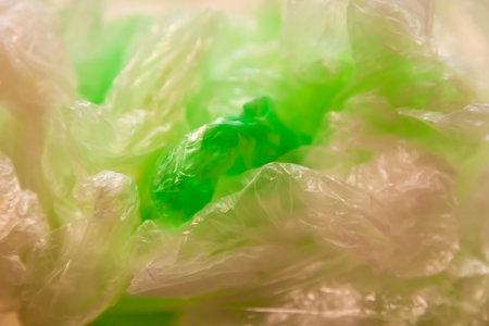 Macro study of translucent plastic bags. Shallow depth of field blurs edges, emphasizing wrinkled texture and luminous highlightsの写真素材