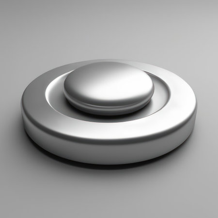 A glossy metallic button featuring a prominent dome shape, set on a circular base. The smooth surfaces reflect light, contributing to a modern appearanceの素材
