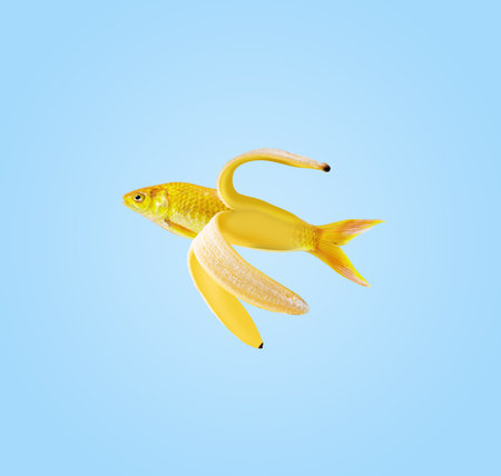 Contemporary art collage. Fish and banana on a blue background. Modern food concept.の写真素材