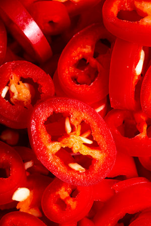 The texture of chopped chilli peppers as a background. A close shot of a chilli pepper. macro photo. Fresh chopped chili peppers. Close-up.の写真素材