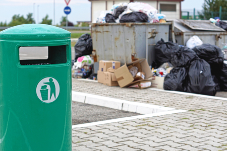 Overflow of garbage litter and empty trash canの写真素材