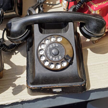 Black bakelite retro telephone at flea marketの写真素材