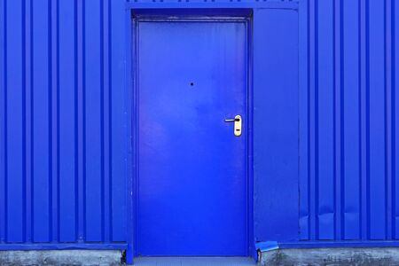 Blue door at industrial building exteriorの写真素材