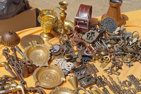 Antique bronze and brass objects for sale at flea marketの写真素材