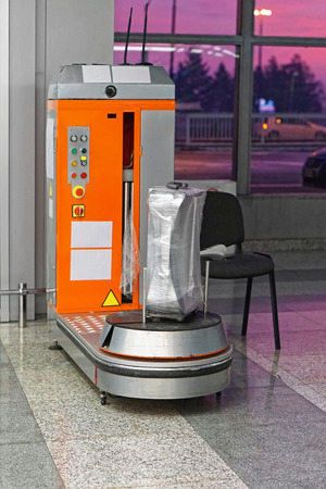 Plastic wrap luggage machine at airportの写真素材
