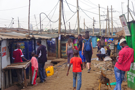 Nairobi, Kenya - July 10, 2017: Tourists and locals walking at street of Kibera slum in Nairobi, Kenya.のeditorial素材