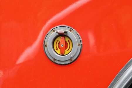 Emergency stop button at red vehicle exterior