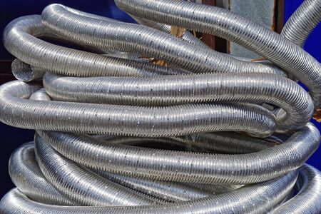 Big bunch of flexible aluminium hoses and pipesの写真素材