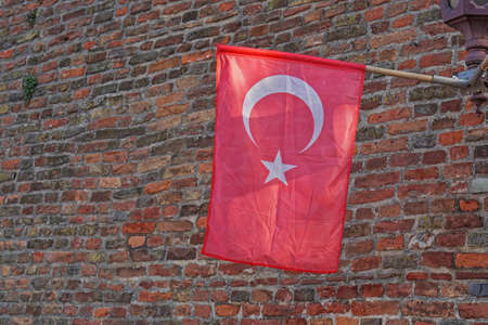 Official Turkey flag with star and crescent at brick wallの写真素材