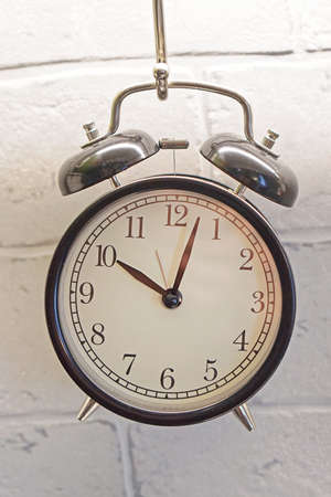 Big old analog alarm clock with bellsの写真素材