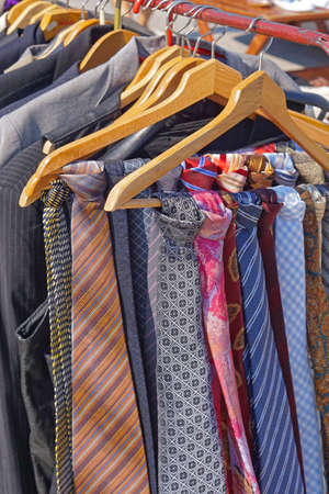 Colourful silk neck ties assortment at coat hangersの写真素材