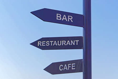 Black sign post for bar restaurant and cafe direction arrowの写真素材
