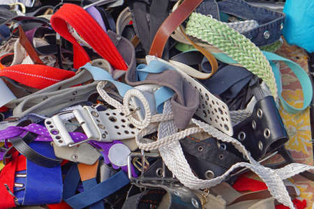 Bunch of used belts at flea marketの写真素材