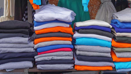 Columns of stacked colorful cotton tee shirtsの写真素材