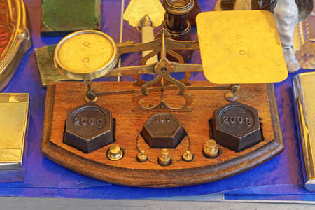 Vintage style weighing scale at shelf in flea market