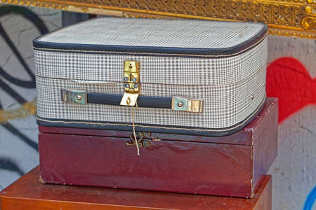 Vintage style suitcase and box at flea market