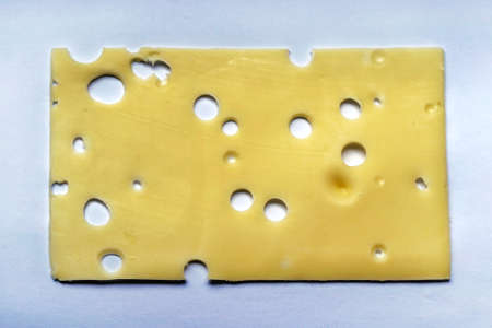 One thin slice of emmentaler cheese with holes