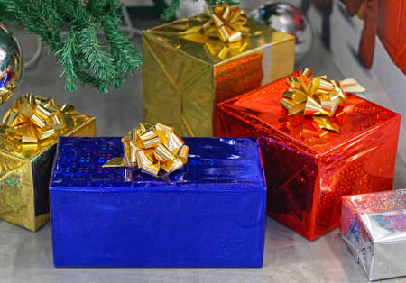 Many gifts in foil under Christmas tree