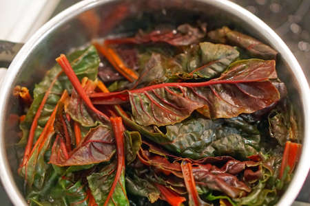 Cooking swiss rainbow chard in potの写真素材