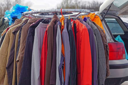 Car boot sale second hand clothing at railingの写真素材