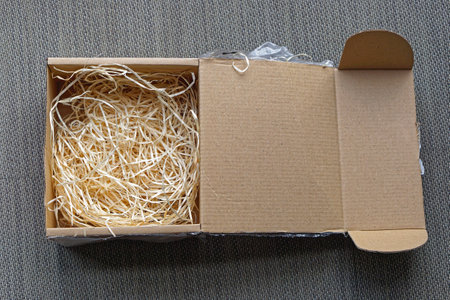 Open cardboard box with fibre nest protection for fragile goodsの写真素材