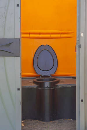 Open seat in portable plastic public toilet cabinの写真素材