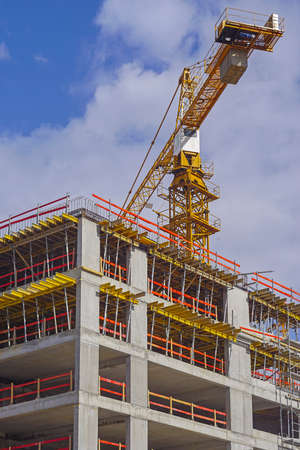 Crane and scaffolding forms at concrete building construction site