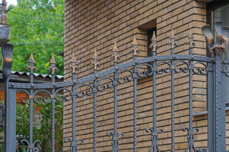Decorative ornate ironwork gate at house fence