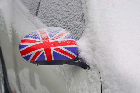 Car covered with fresh snow in Great Britainの写真素材