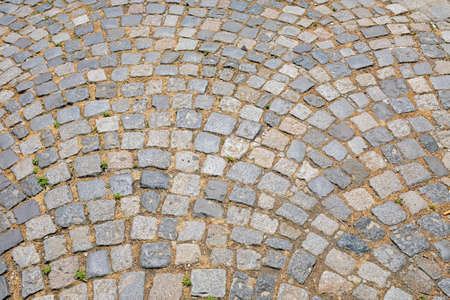 Old square shape cobblestone bricks street pavement surfaceの写真素材